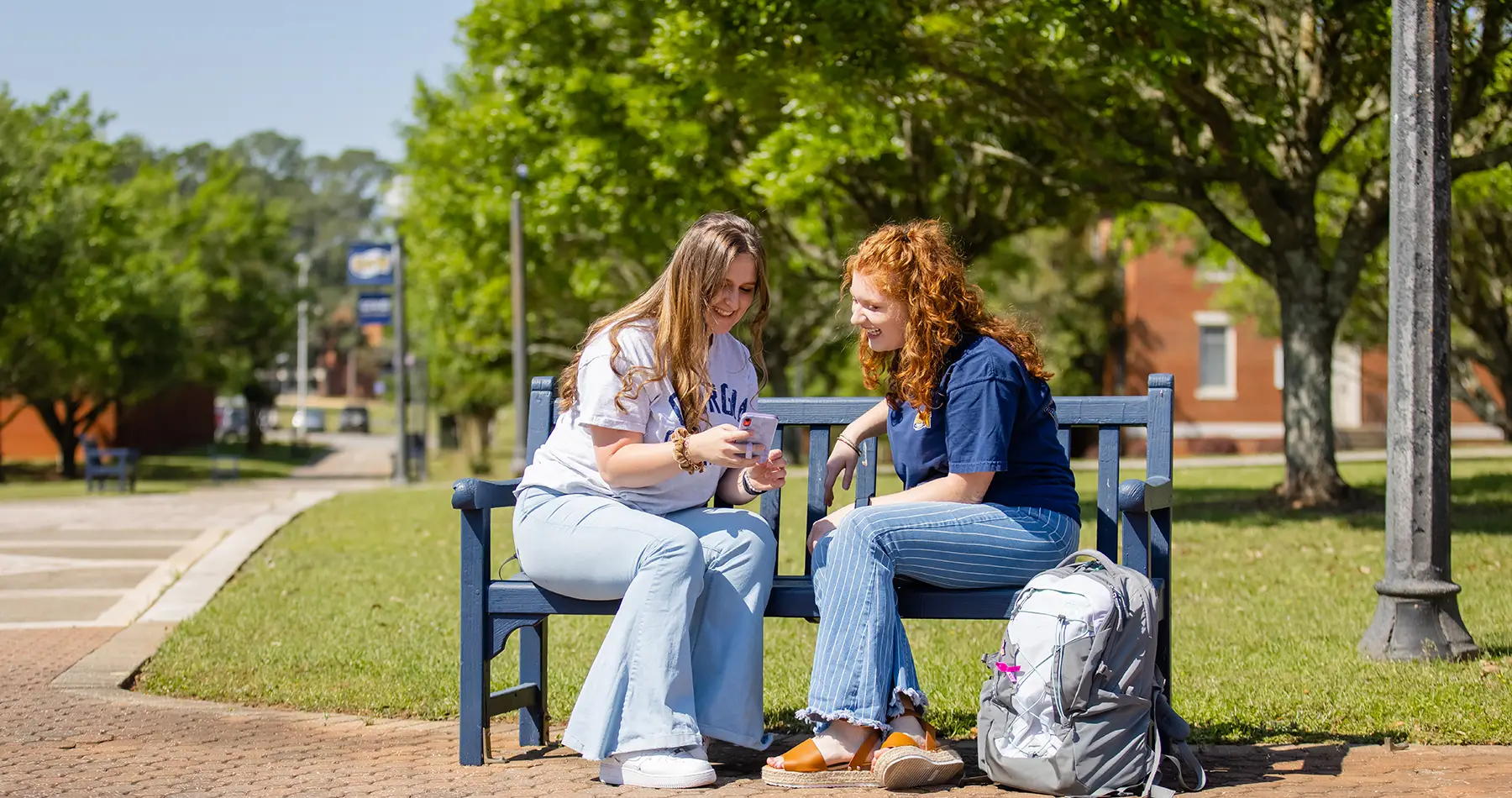 Students sitting outside on bench