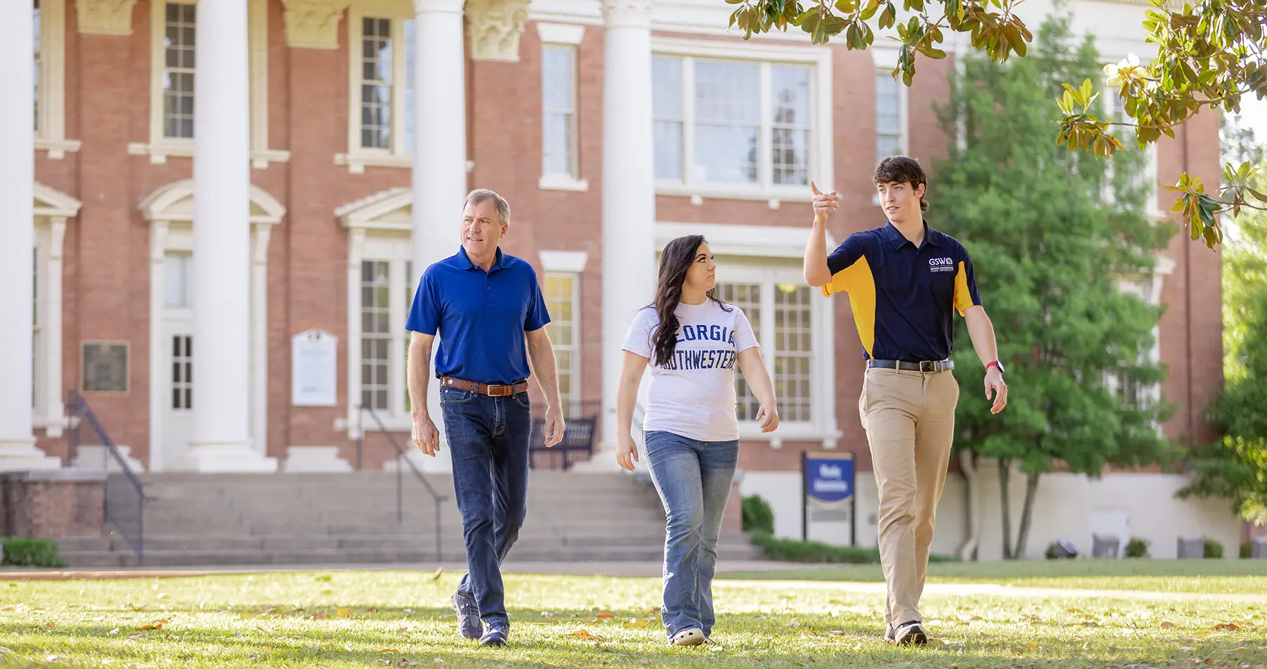 Campus tour guide with a student and their father