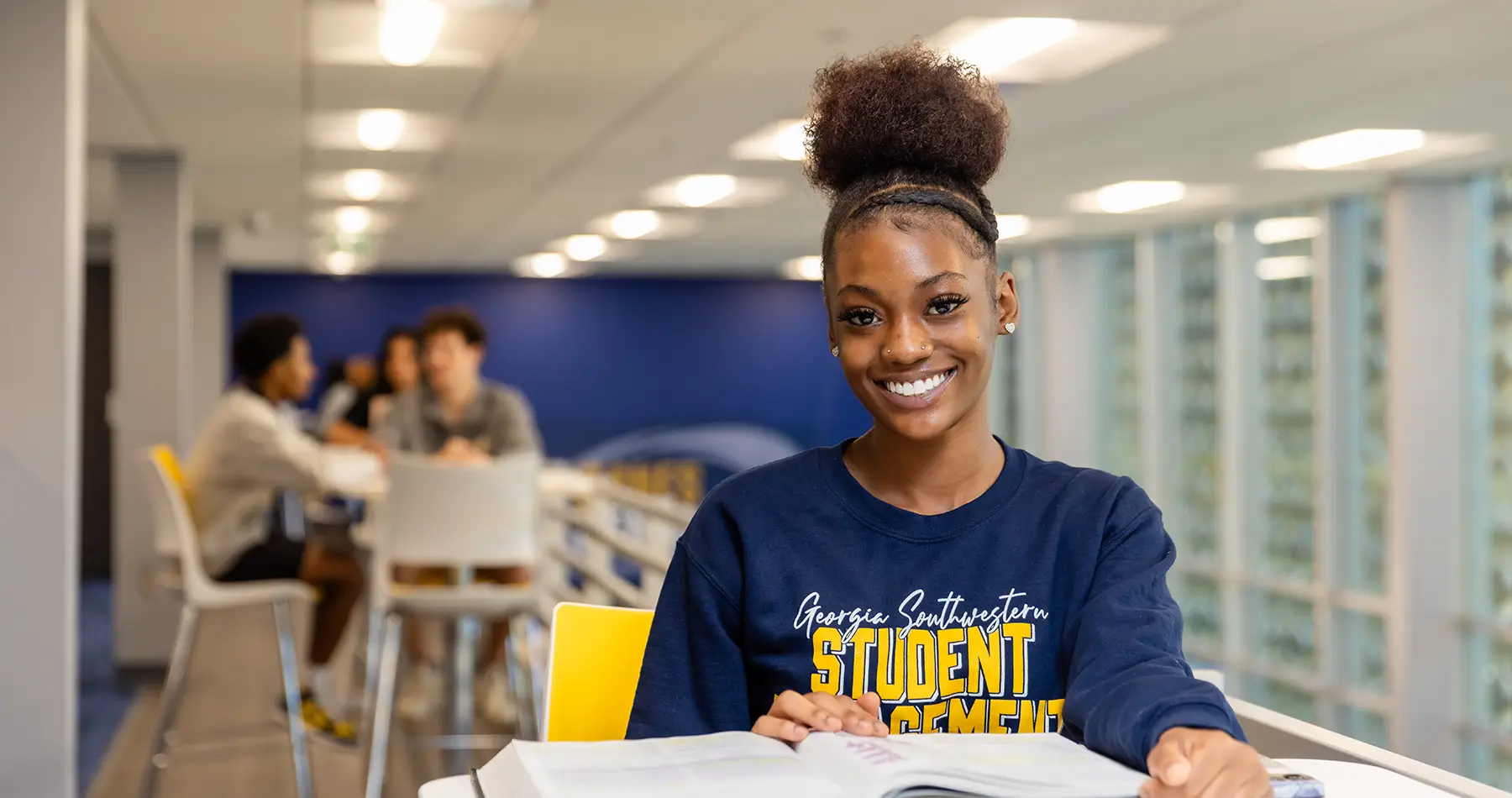 Student sitting in Canes Central building