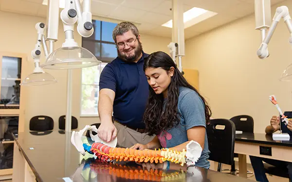 Professor and student studying in lab