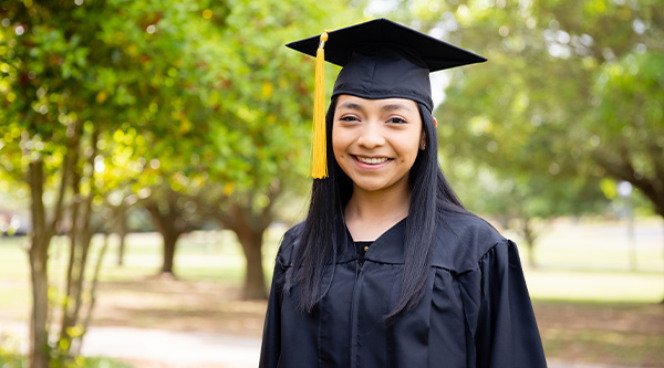 student wearing cap and gown