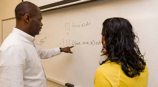 Student completing math equation