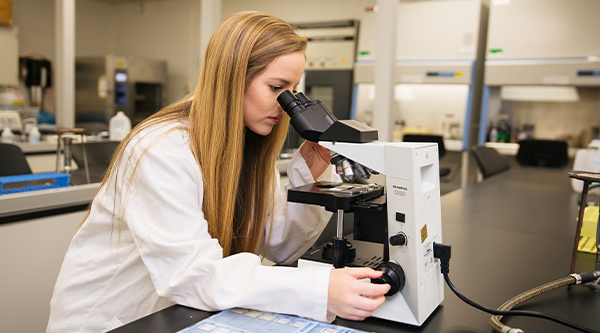 biology student with microscope