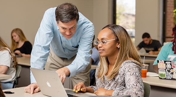 Professor providing assistance to student