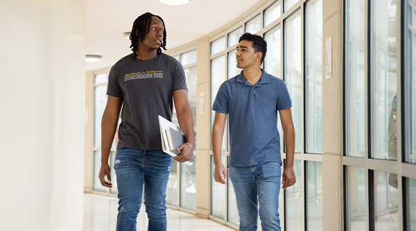 Students walking in hall of dome