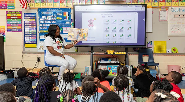 Female student teacher reading to students