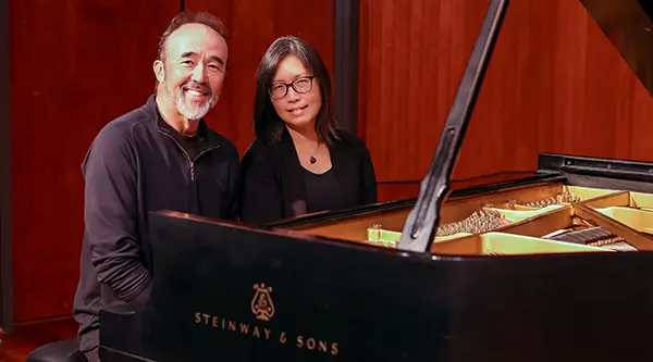 Duo Fuerza sit behind piano