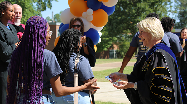 President Johnston handing students their Silver Challenge Coins