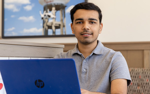 Student on laptop, online computer science program