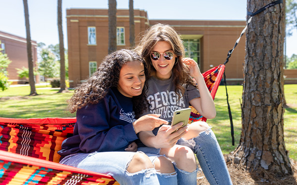 Students on GSW campus in hammock