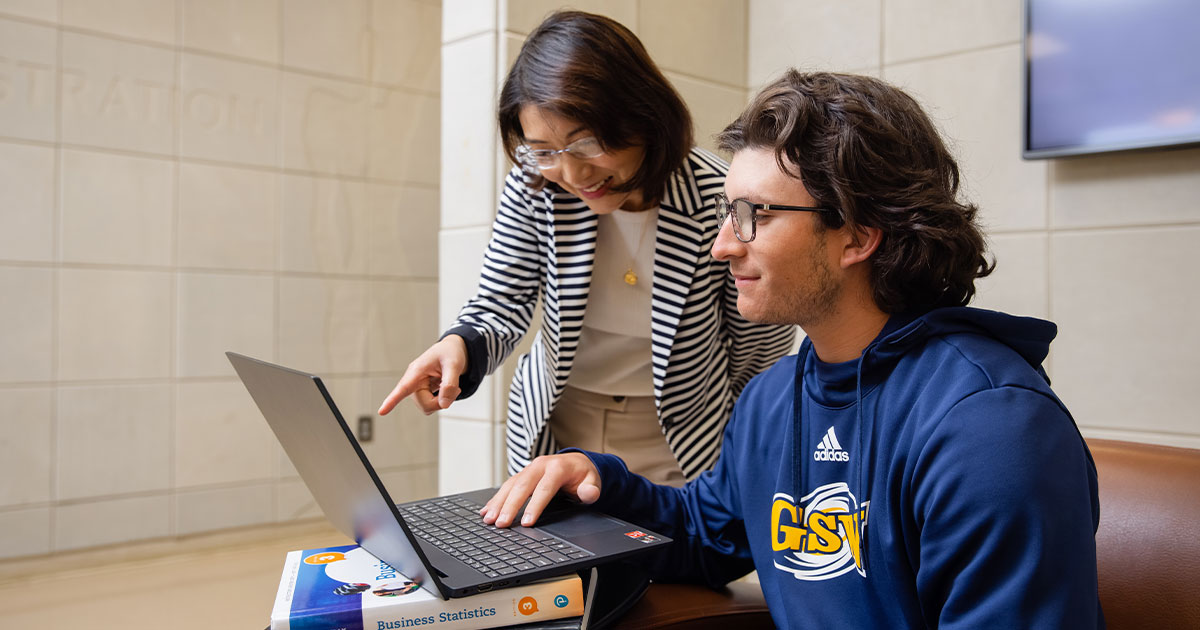 faculty member assisting student