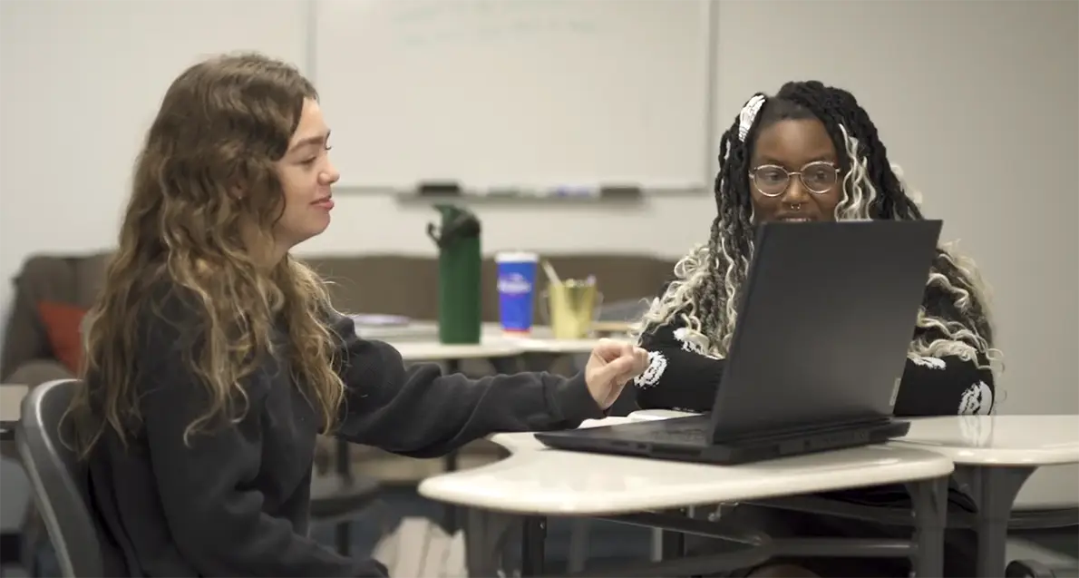 Writing Center consultant helping a student