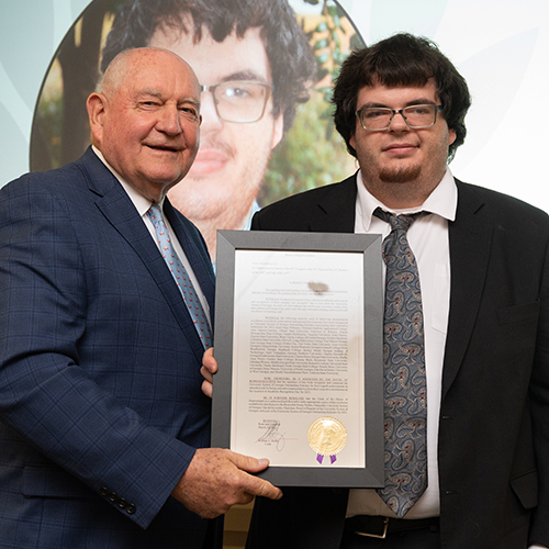 Charles Doswell accepts his Outstanding Scholar award from USG Chancellor Sonny Perdue