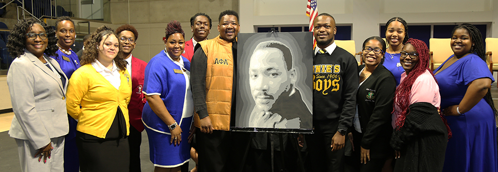 NPHC member with MLK painting