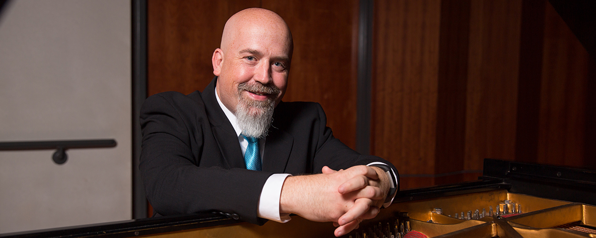 Dr. Mark Laughlin at his piano