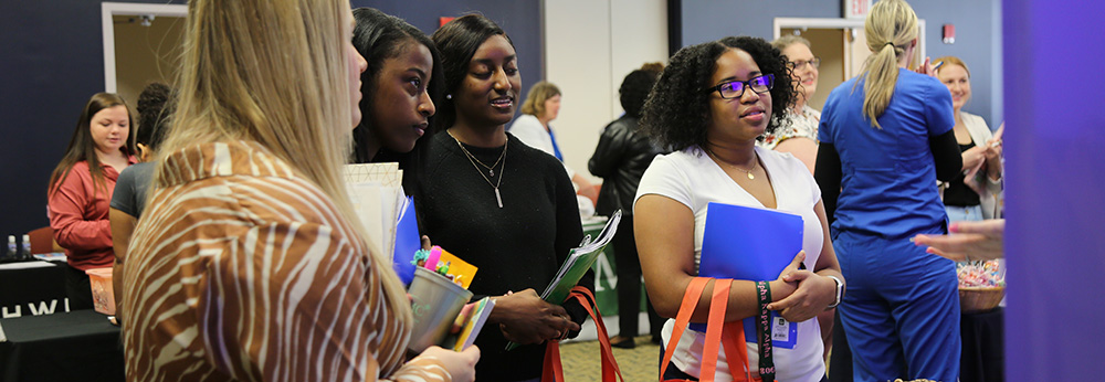 students meet with potential employers at career fair