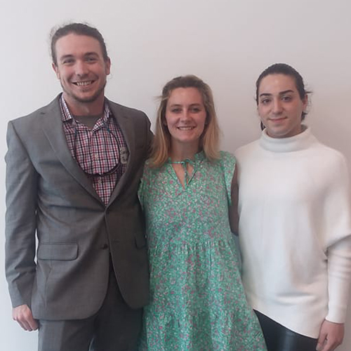 three students pose for photo at conference