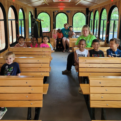 students and teachers ride trolley