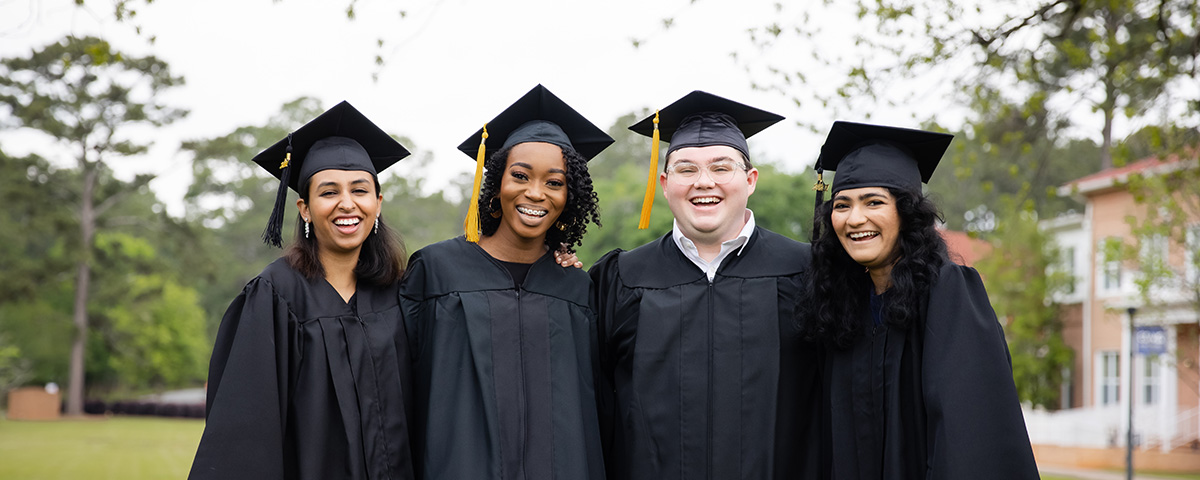 students in caps and gown celebrate