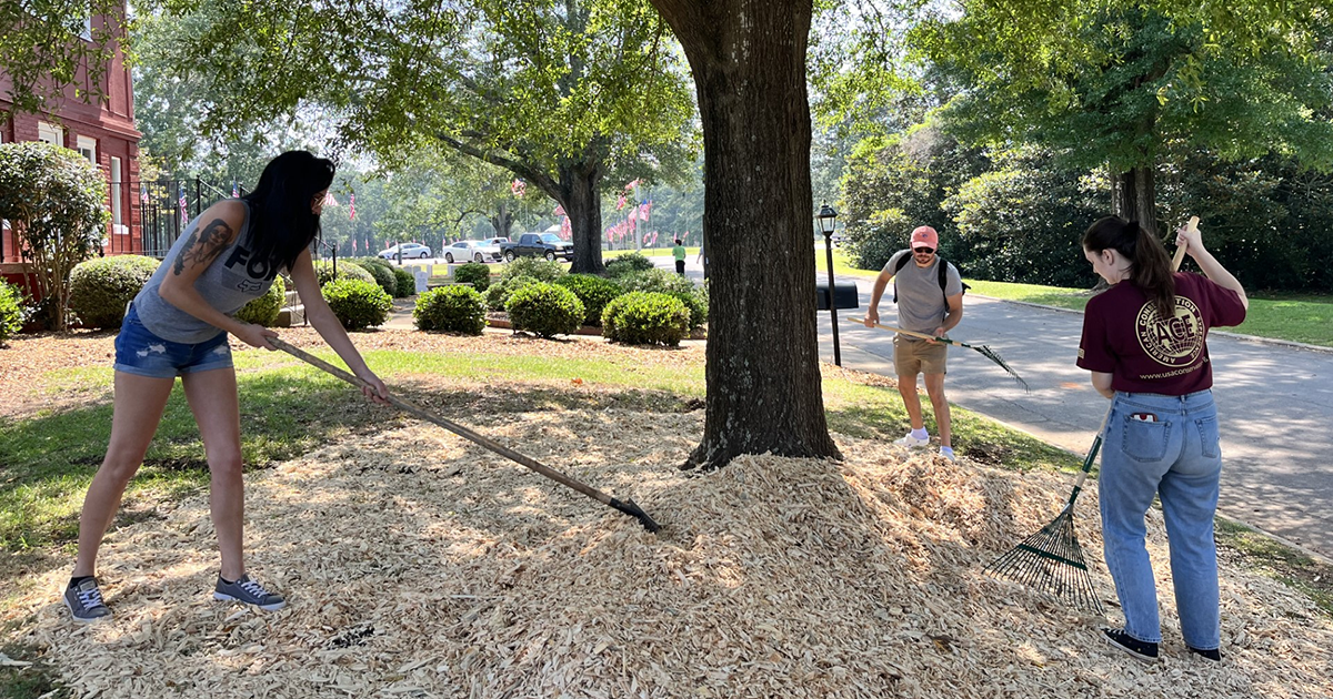 student spread mulch