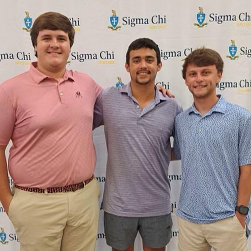 Three Sigma Chi brothers at conference