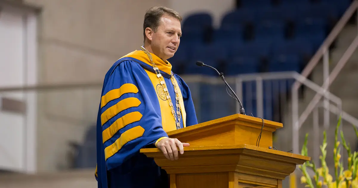 Weaver speaks at podium