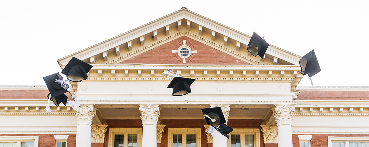 graduation caps in the air