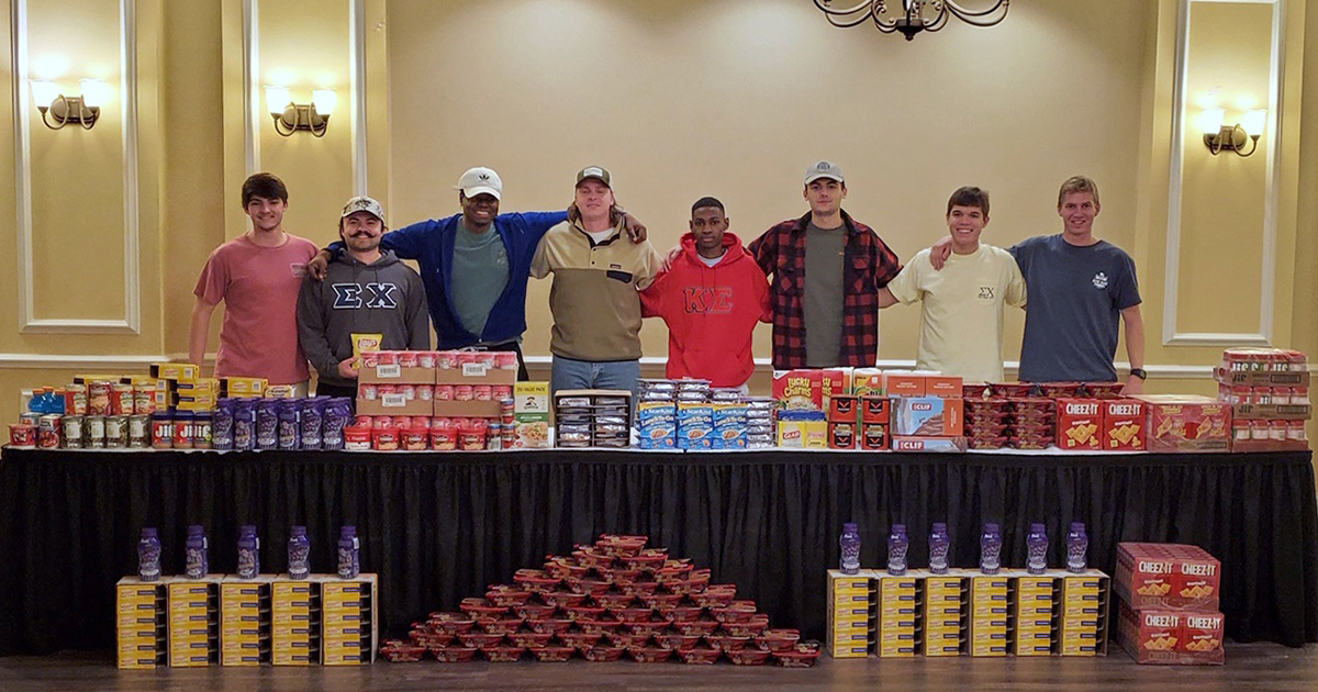 brothers stand with food donations