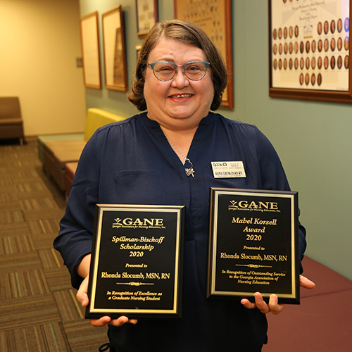 Rhonda Slocumb holding awards