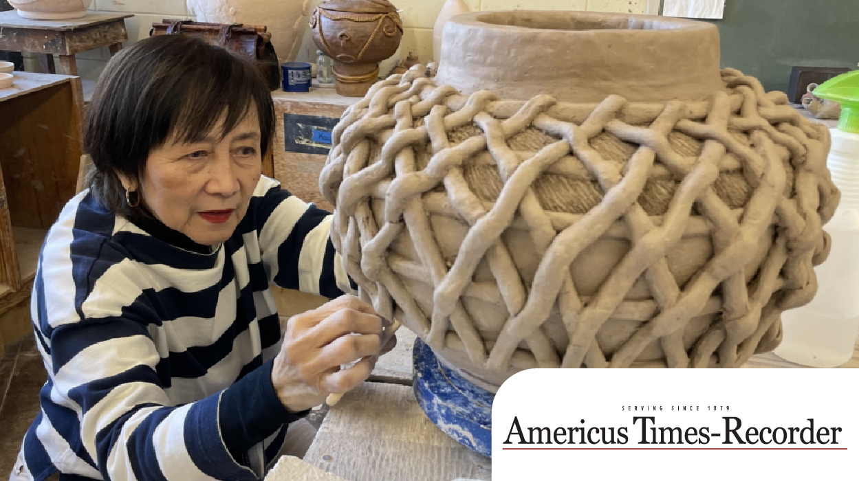 student working on pottery