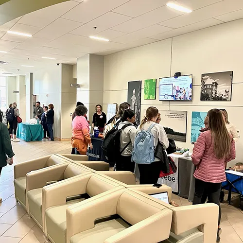 students visit tables at externship fair