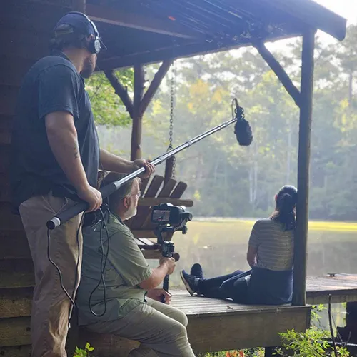 two men with camera and microphone shoot film