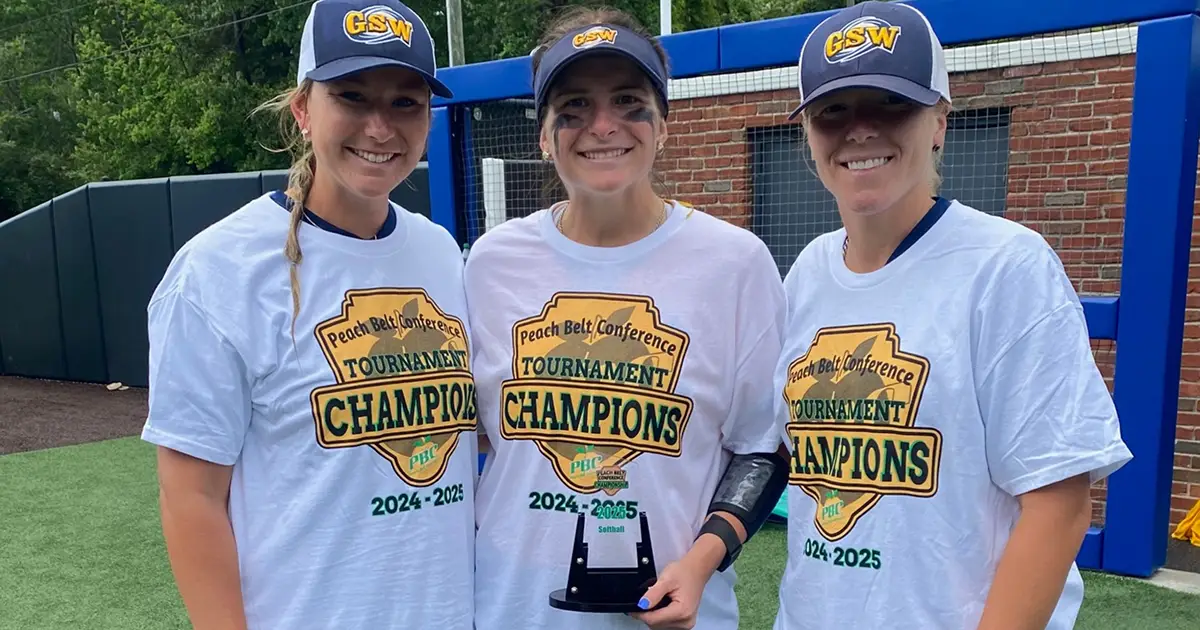 three softball players with trophy