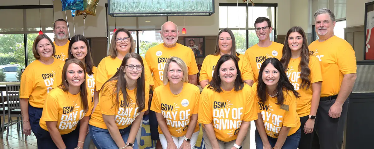group in gold shirts