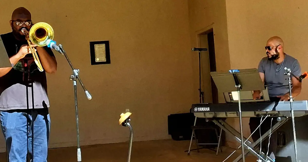 men playing trumpet and keyboard