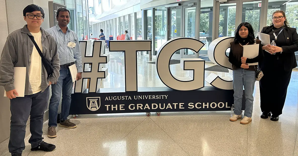 students in front of Augusta University grad school sign