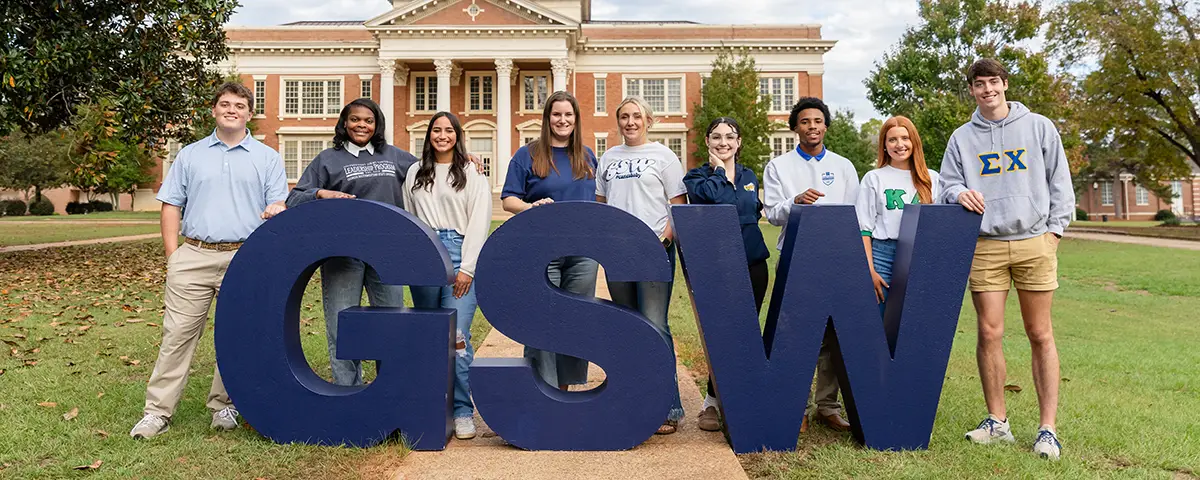 students standing around large GSW letters 