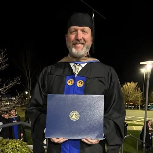 Jeff Hall in graduation regalia