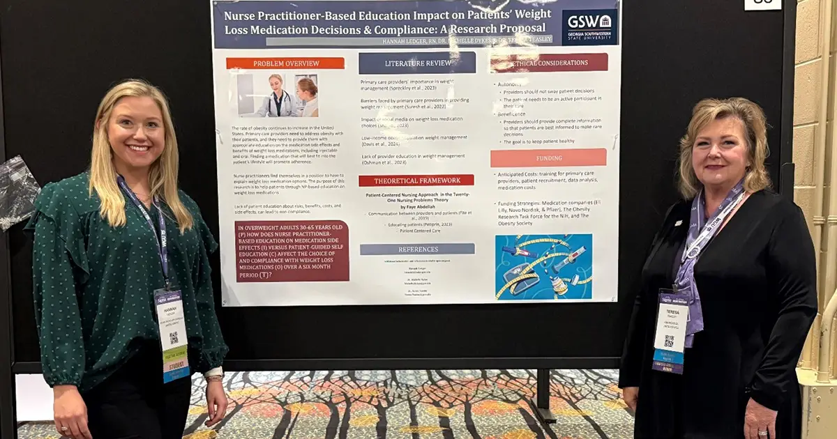 Hannah and Dr. Teasley in front of research poster