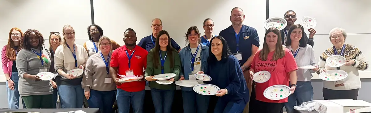 group of teachers hold cell models