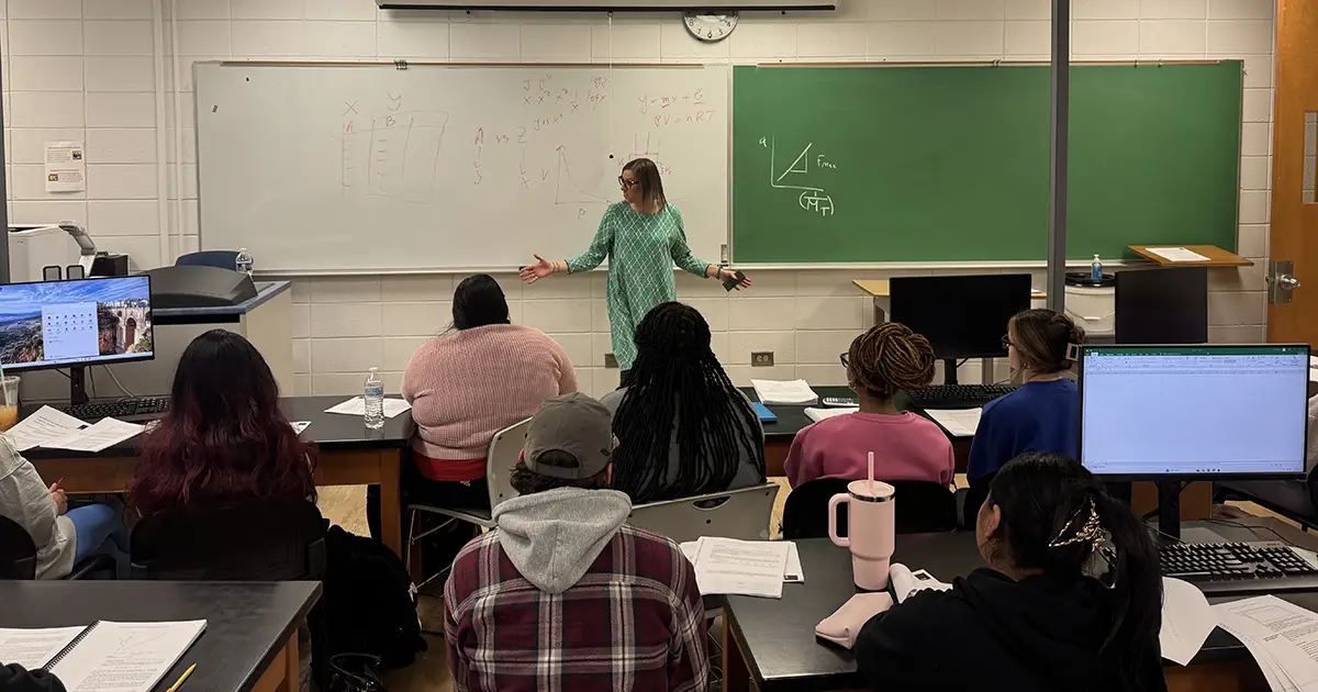 Becca Jones speaks in front of classroom