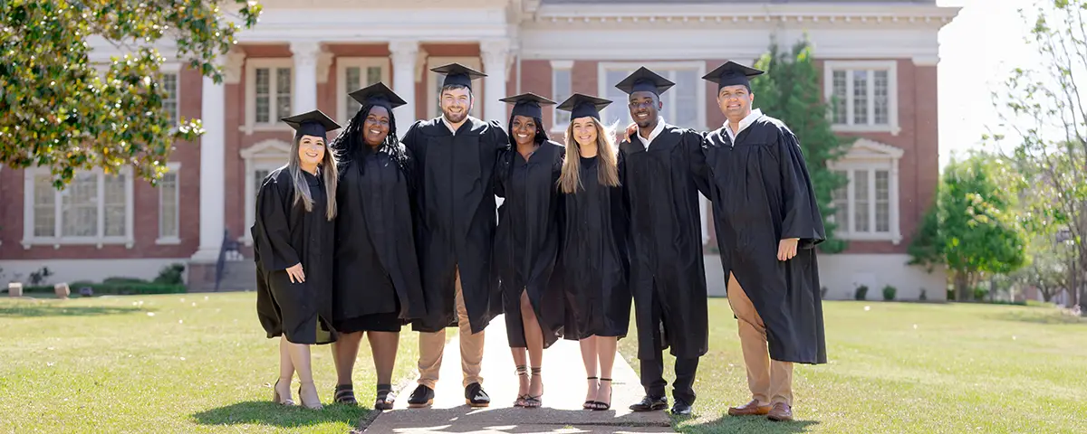 group of graduates in front of the Wheatley Administration building