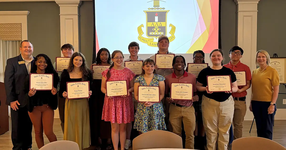 Students hold certificates