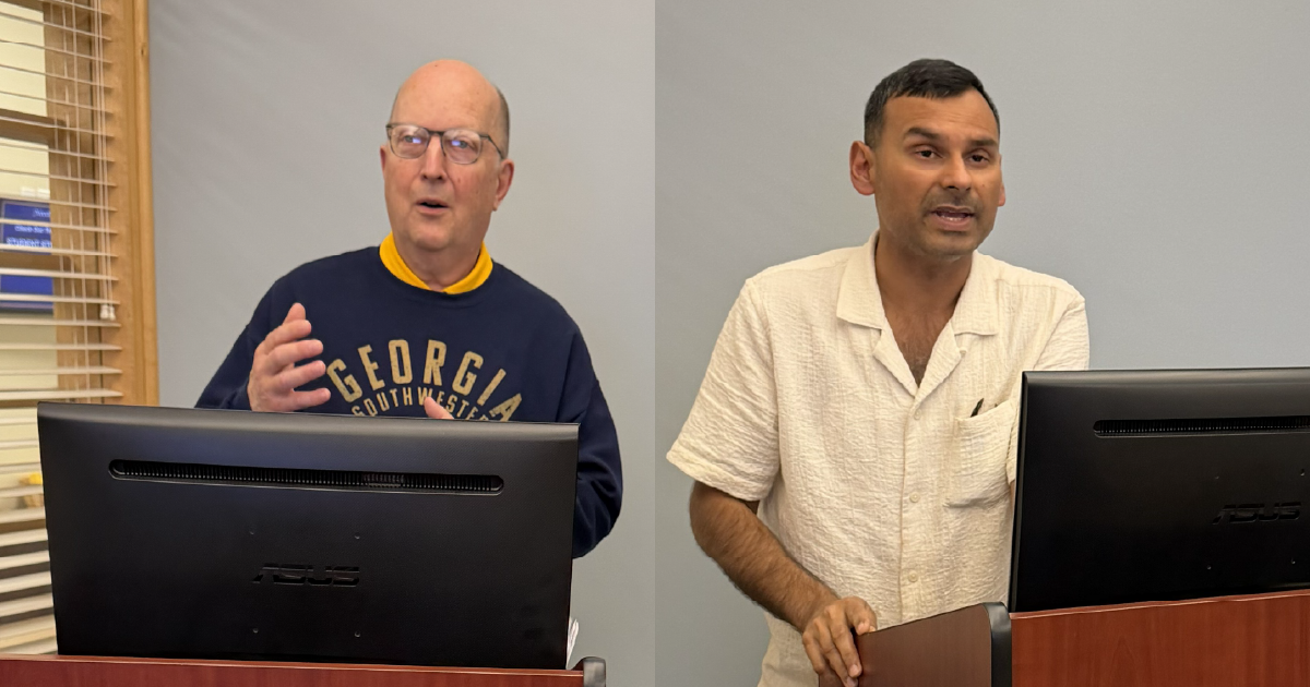 Mallett and Banerjee present at podiums
