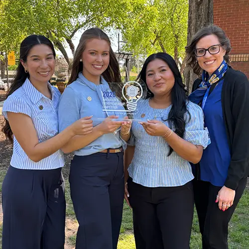 students hold trophy