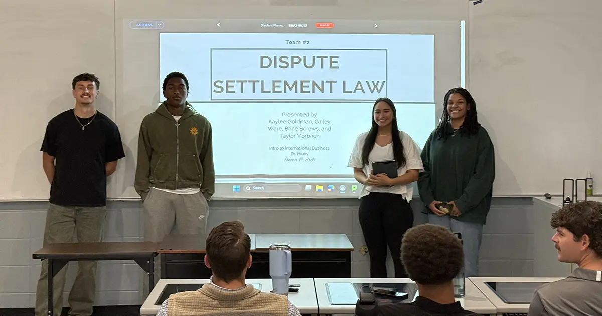 students pose with presentation