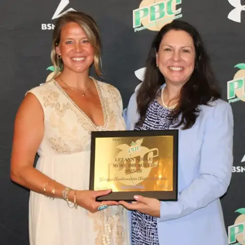 Caitlin Downs accepts plaque from PBC representative