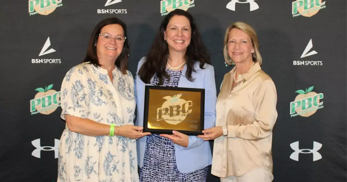 Michelle Johnston and Gaye Hayes accept plaque from PBC representative