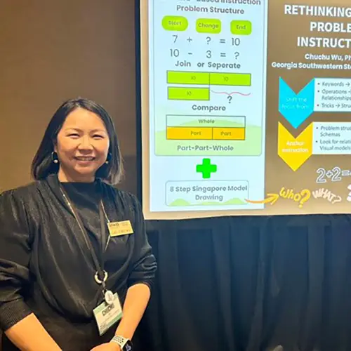 Chuchu Wu stands next to presentation