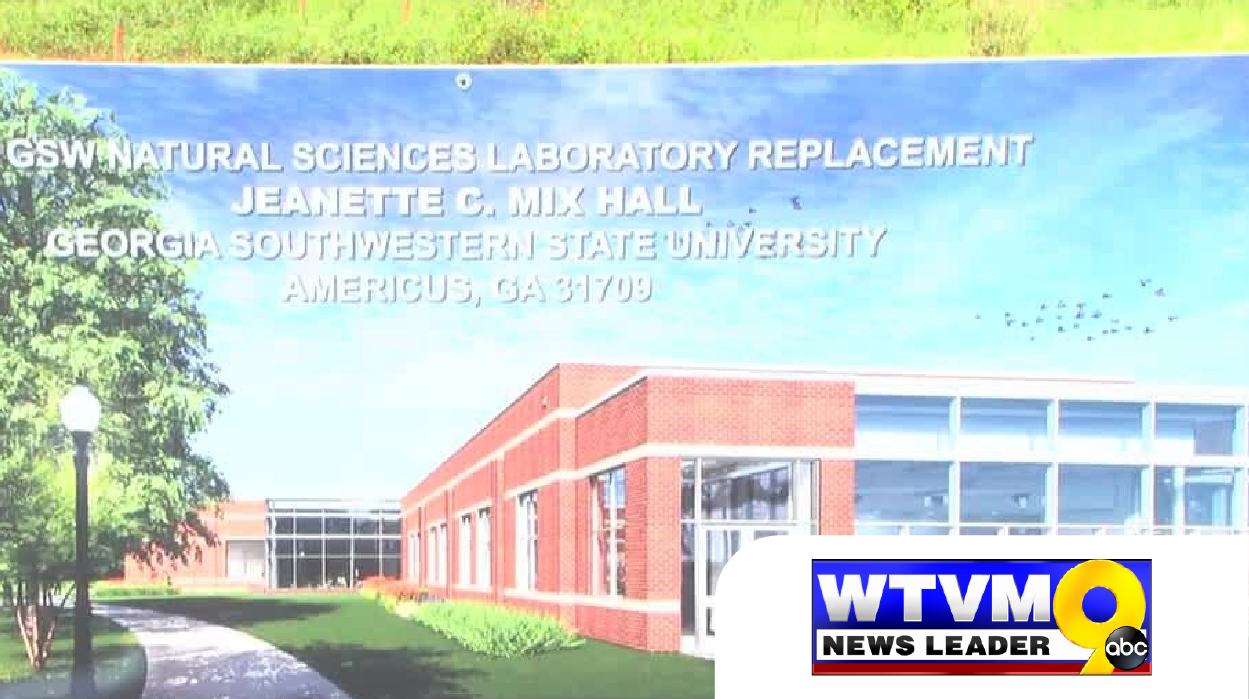 screen grab of a news segment that shows a sign with a building rendering